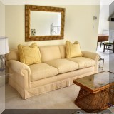 F63. Custom sofa upholstered in cream Manuel Canovas fabric. 30”h x 86”w x 38”d 